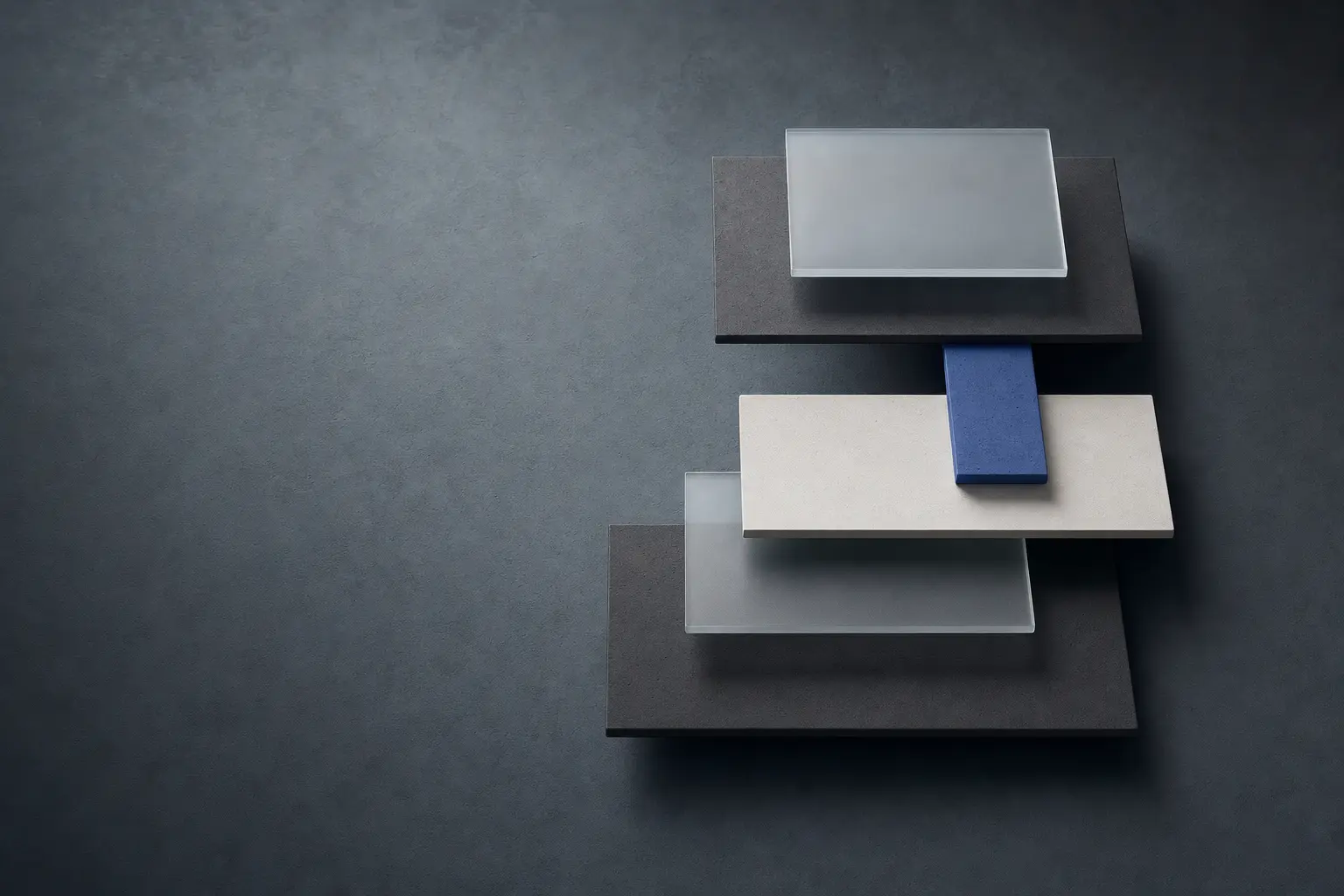 Abstract composition of charcoal panels, cobalt light, and translucent material intersections.