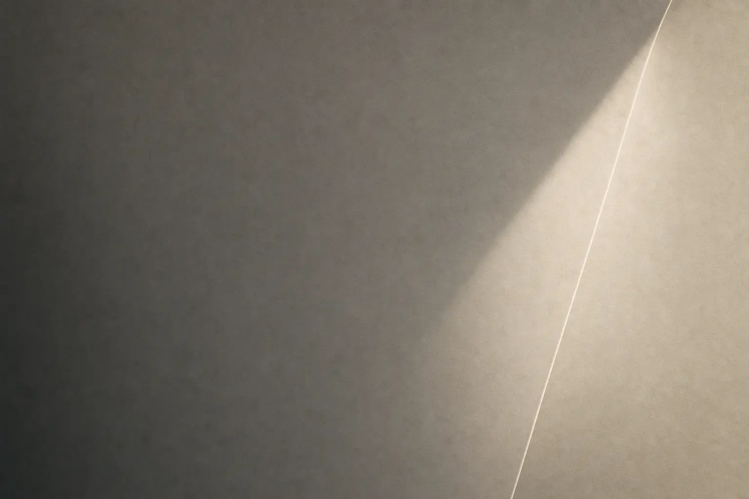 Charcoal paper field crossed by a slim warm beam of light.